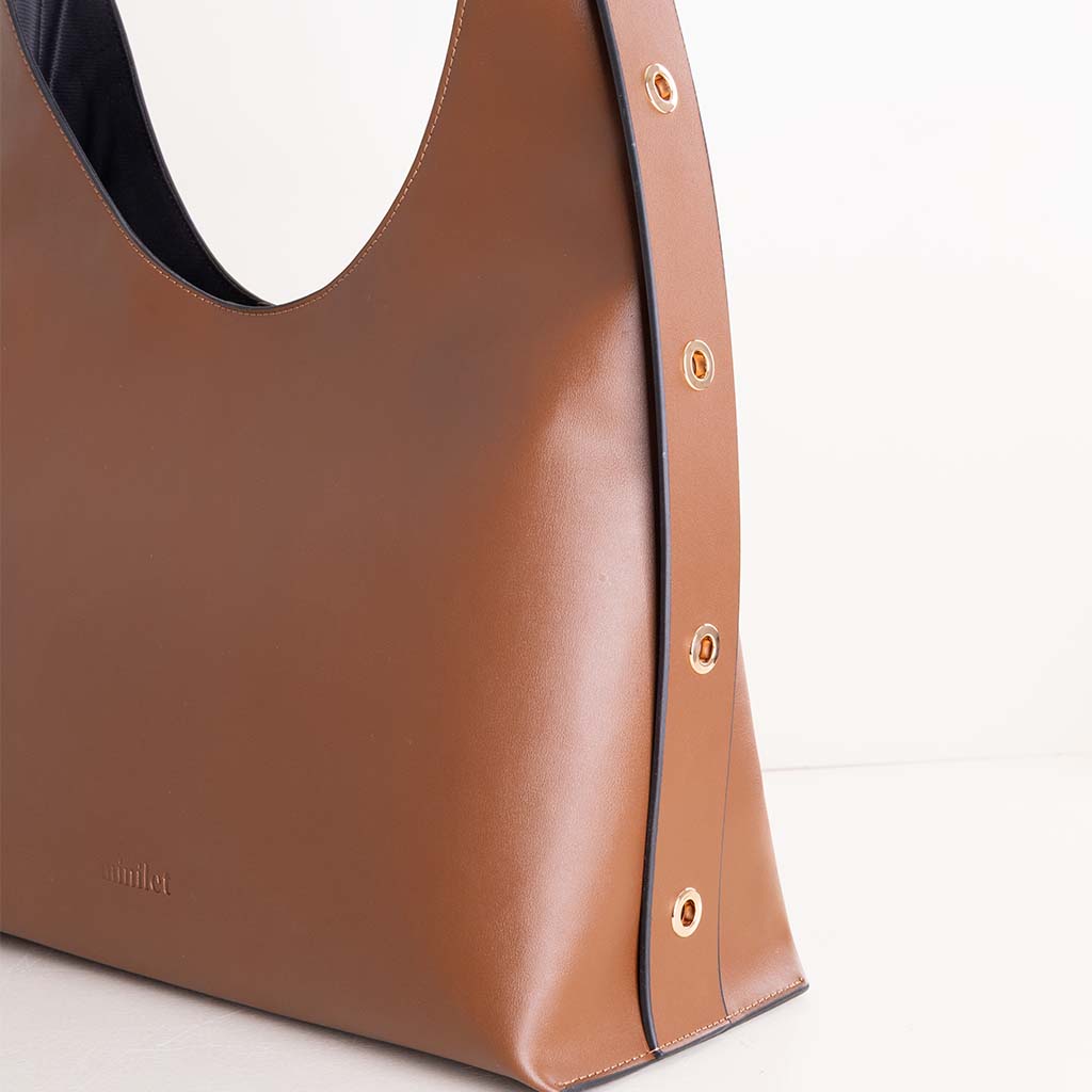 product-image-حقيبة مينيلت الجلدية البنية مزينة بفتحات معدنية